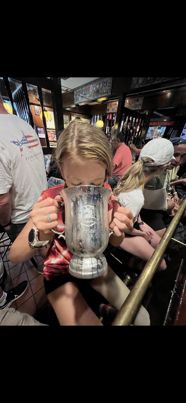 Adrianne Haslet celebrating with a race trophy