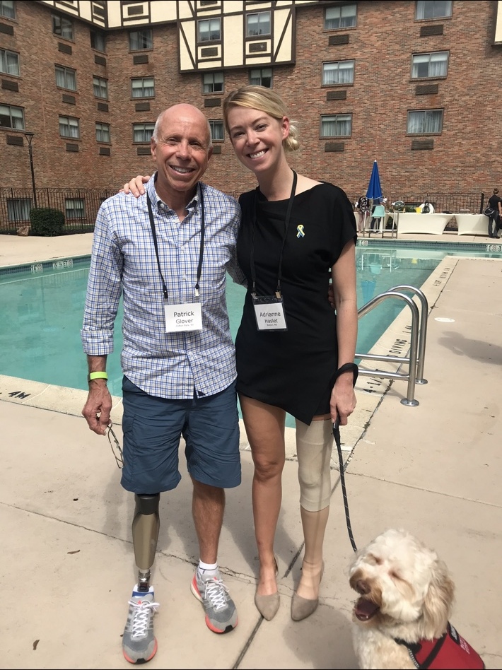 Adrianne Haslet with fellow amputee Patrick Glover and a service dog